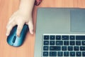 Child`s hand holds a computer mouse, child learns and plays on the computer Royalty Free Stock Photo