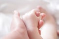 The child`s hand holds the finger of an adult Royalty Free Stock Photo
