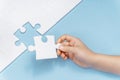 A child`s hand makes the last missing piece of the puzzle. business concept Royalty Free Stock Photo
