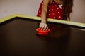 Child`s hand playing air hockey game. Copy space Royalty Free Stock Photo