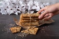 A child's hand reaches for grain bread with seeds of flax, sesame, sunflower Royalty Free Stock Photo