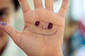 Child's hand with smiley face