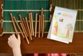 Child's hand takes the pencil on table to draw