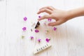 Child`s hand touching butterfly. Wooden background with august sign and willow herb flowers Royalty Free Stock Photo