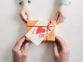 Child's hands and adult man's hands  beautiful gift box Royalty Free Stock Photo
