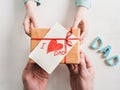 Child's hands and adult man's hands  beautiful gift box Royalty Free Stock Photo