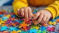 Child's hands assembling a colorful puzzle. Royalty Free Stock Photo