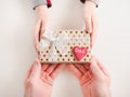 Child`s hands and a beautiful gift box Royalty Free Stock Photo