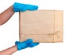 Child`s hands in blue mittens hold a rectangular cardboard box with a gift isolated on a white background Royalty Free Stock Photo