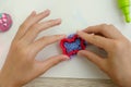 Child`s hands with colored plasticine.