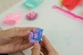 Child`s hands with colored plasticine.