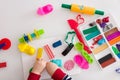 Child`s hands with colorful clay. Toddler playing and creating toys from play dough. Boy molding modeling clay