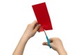 Child`s hands cutting colored red paper with scissors isolated o Royalty Free Stock Photo