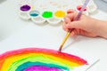 Close up of kid`s hand painting rainbow Royalty Free Stock Photo