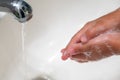 A child washing his hands with soap in bathroom sink Royalty Free Stock Photo