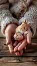 Child\'s hands gently holding a tiny chick, symbolizing care and tenderness in a soft light setting Royalty Free Stock Photo