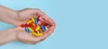 Child`s hands hold many colorful vitamins, capsules, supplements, pills Royalty Free Stock Photo