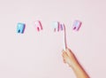 Child`s hands holding big tooth and toothbrush on pink backgroubd. Healty care teeth concept. Top view, flat lay. Copy Royalty Free Stock Photo