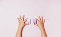 Child`s hands holding big tooth and toothbrush on pink backgroubd. Healty care teeth concept. Top view, flat lay. Copy space for Royalty Free Stock Photo