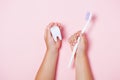 Child`s hands holding big tooth and toothbrush Royalty Free Stock Photo