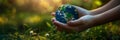 Child& x27;s hands holding earth globe over green plants background Royalty Free Stock Photo