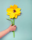 Child's hands holding a handmade sunflower