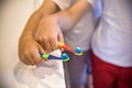 Child`s hands holding toothbrush on pink backgroubd. Healty care teeth concept. Copy space for your text Royalty Free Stock Photo