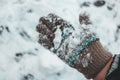 Child`s hands in knitted woollen gloves in snow. Royalty Free Stock Photo