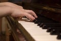 Child's hands on the piano roll