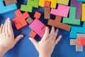 Child`s hands playing with colorful wooden blocks