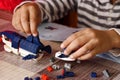 Child`s hands playing with a small lego bricks