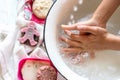 ChildÃ¢â¬â¢s hands under white bowl with water upon water stream Royalty Free Stock Photo