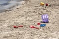 A child`s losted plastic sand buckets raker and scoop at the beach. Sunny day on Mediterranean sea