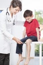 Child's neurologist testing knee reflex