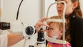 Child`s ophthalmology - doctor optometrist checks eyesight for patient - little girl Royalty Free Stock Photo