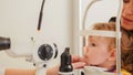 Child`s optometry - little girl hecks eyesight in eye ophthalmological clinic Royalty Free Stock Photo