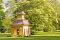 Child`s playhouse on green grass of historic mansion