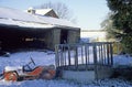 Farmyard in UK. Winter snow on fields and barns