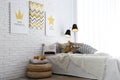 Child`s room interior with bed and posters on wall Royalty Free Stock Photo