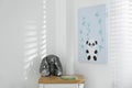 Child`s room with chest of drawers, toy bunny and cute poster on wall