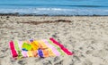 2 child`s sand pails and shovels on a striped beach towel at the ocean Royalty Free Stock Photo