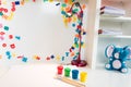 A Child`s School Desk with School Supplies, colorful paint, and a stuffed blue elephant toy.