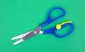 Child's scissors on green craft paper