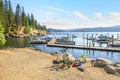 Kids play at a lakeside dock and marina in a mountain town