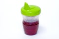 Child's sippy cup with juice Royalty Free Stock Photo