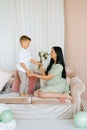 The child`s son gives his mother a bouquet of flowers. Happy Mother`s Day Royalty Free Stock Photo