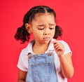 Child, sad and finger injury with plaster on isolated red background for cut, sore and insect bite. Upset, unhappy and