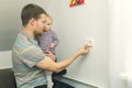 Child safety at home. father protect kid from electrical injury Royalty Free Stock Photo