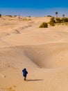 child in the Sahara desert plays with the sand of the dunes, tourist on vacation