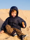 child in the Sahara desert plays with the sand of the dunes, tourist on vacation